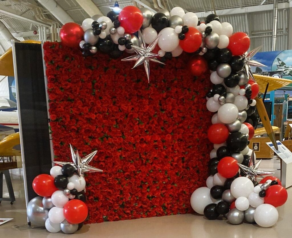 Red Roses Flower Wall Brampton with Multi-Coloured Balloon Decor