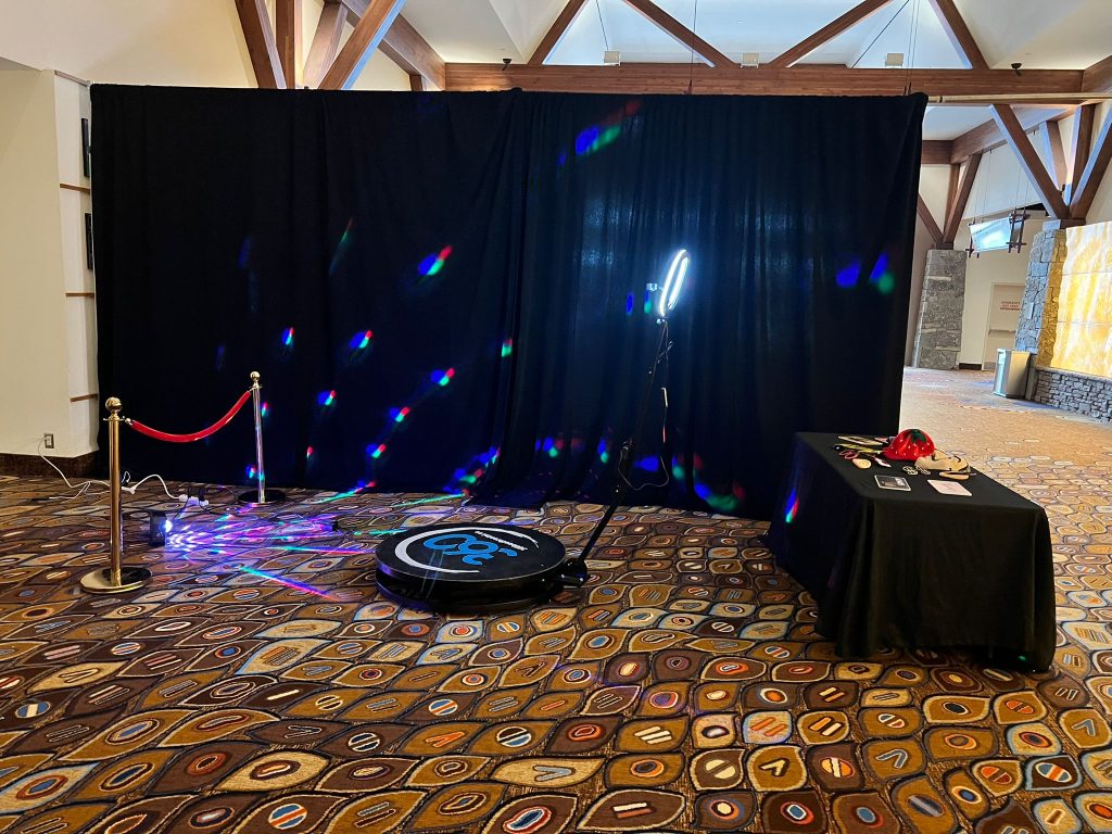 360 video booth with a backdrop and props